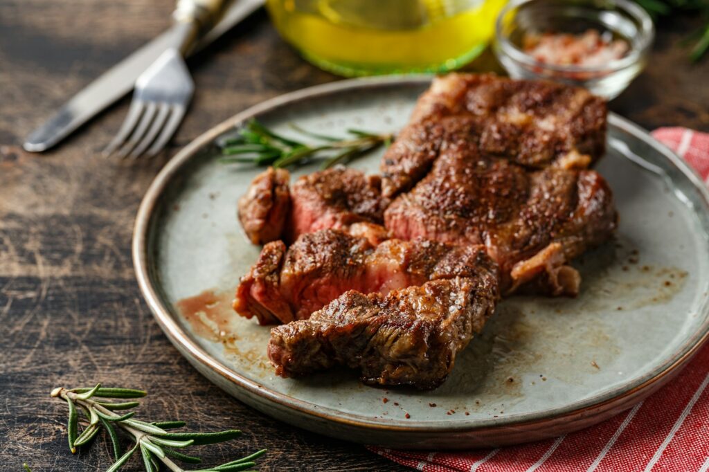 Two beef steak on dark gray background